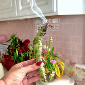 A woman holding sage.