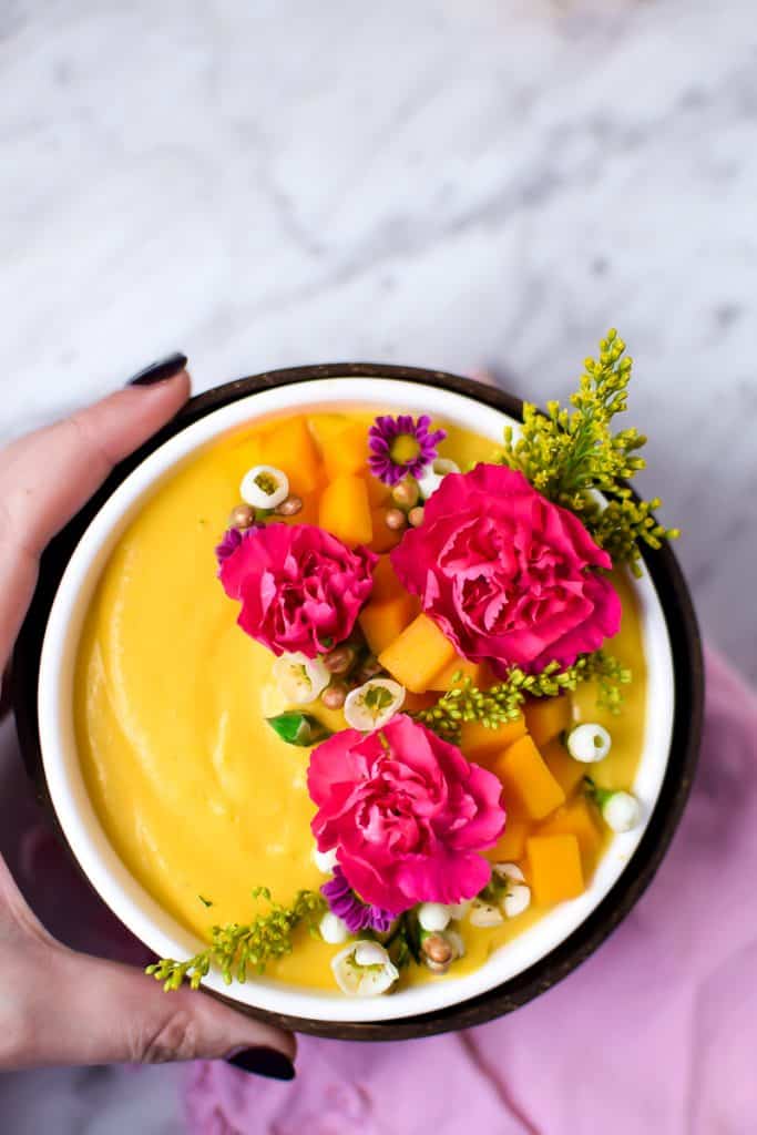 Springtime Mango Smoothie Bowl with Edible Flowers by Emily Kyle Nutrition