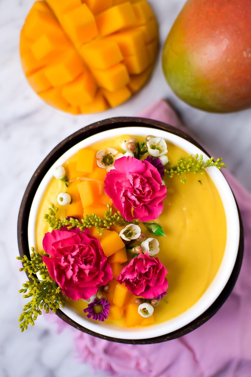 Springtime Mango Smoothie Bowl with Edible Flowers by Emily Kyle Nutrition