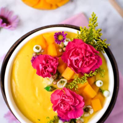 Springtime Mango Smoothie Bowl with Edible Flowers by Emily Kyle Nutrition