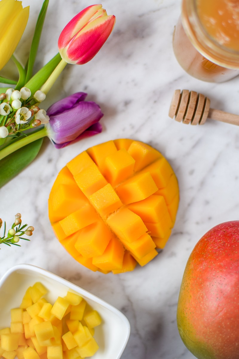 Springtime Mango Smoothie Bowl with Edible Flowers by Emily Kyle Nutrition