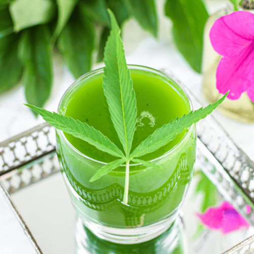 A picture of cannabis juice with a cannabis leaf on top.