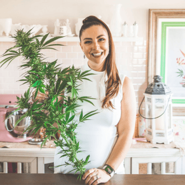A picture of Emily Kyle with a cannabis plant.