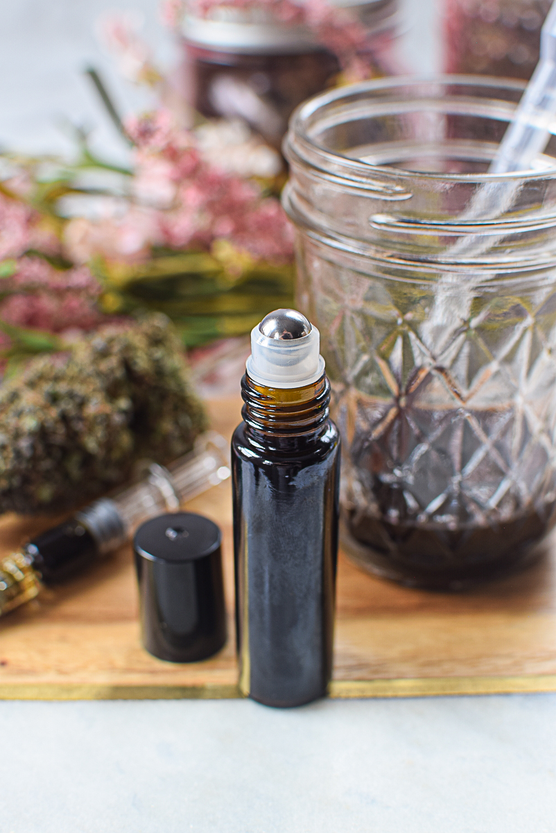 Rejuvenating CBD caffeine eye serum in a glass bottle with a rollerball applicator.