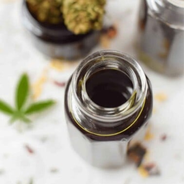 A glass bottle filled with cannabis massage oil.