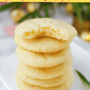 A stack of sugar cookies with the top one with a bite taken out of the middle.