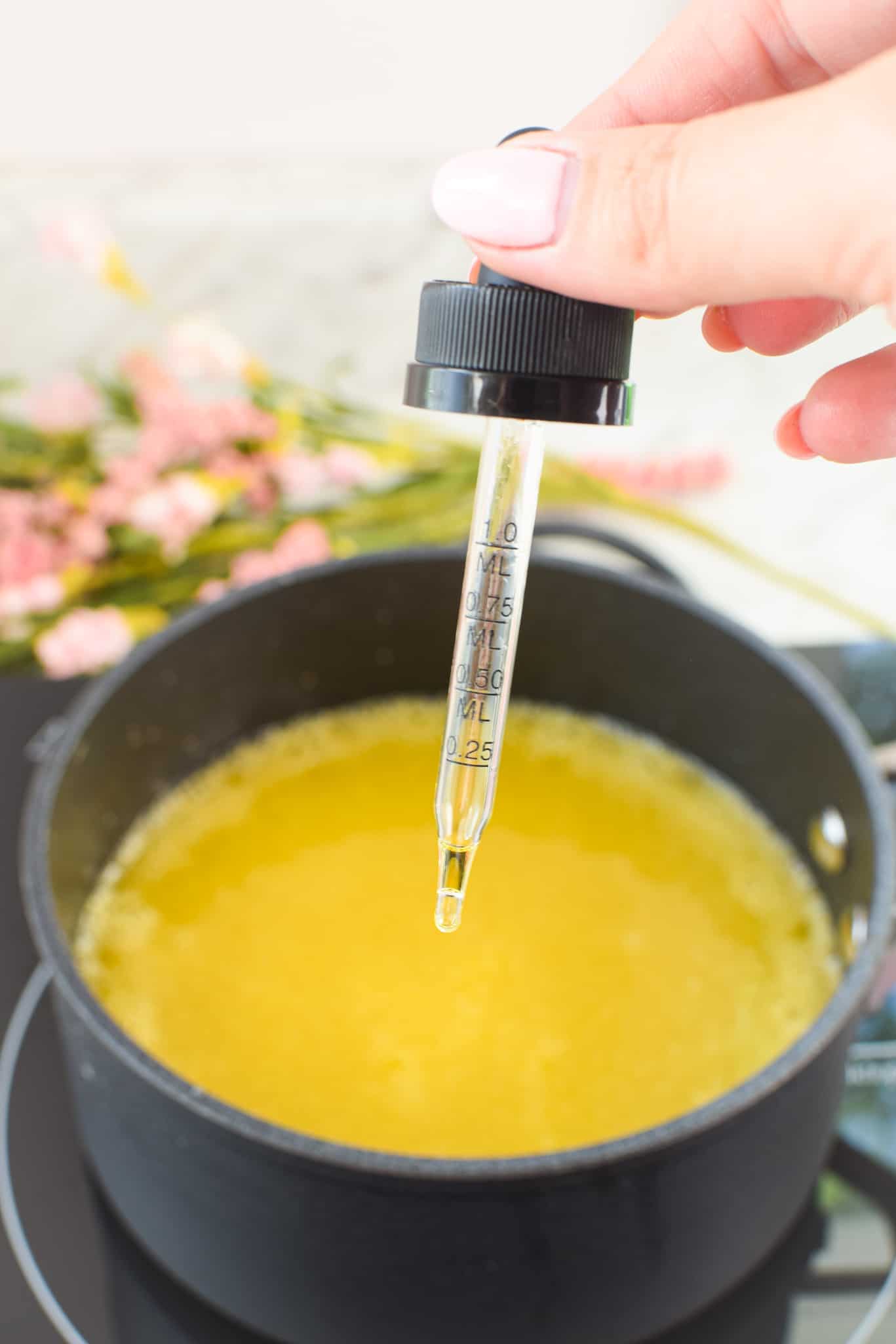 A picture of a CBD oil dropper going into a batch of CBD gummies.