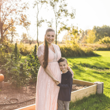 A picture of Emily Kyle with her son in a cannabis garden.