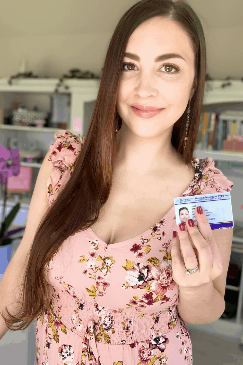 A picture of Emily Kyle holding a medical marijuana card. 