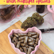 Cannabis capsules in a pink heart-shaped dish with cannabis buds and dropper.
