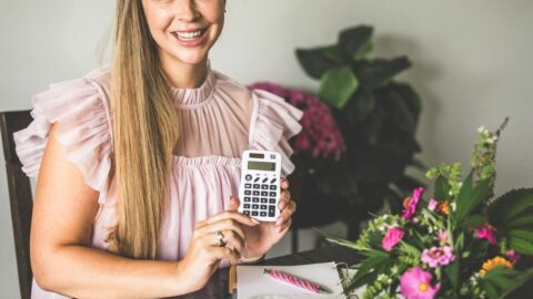 A picture of Emily Kyle with a calculator.