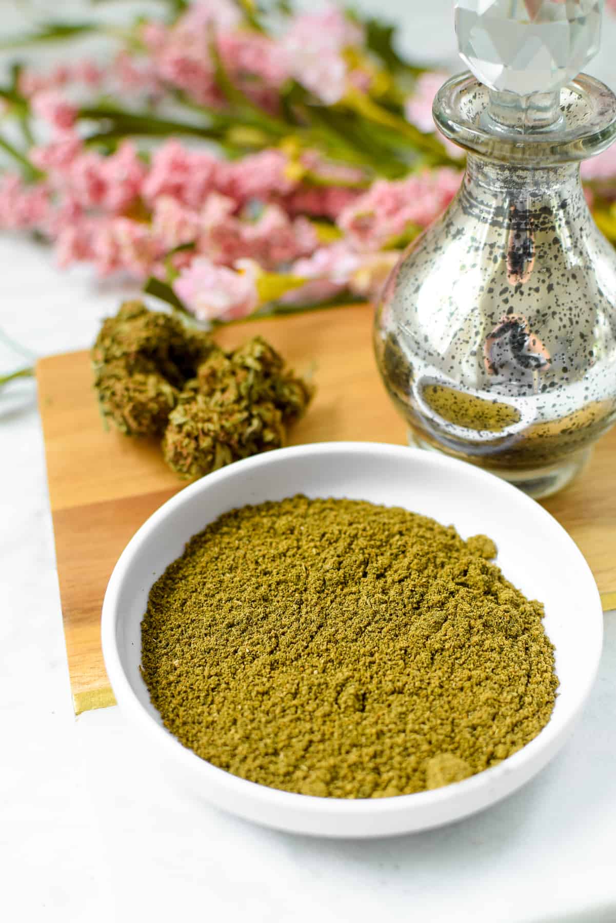 A shallow bowl of green powdered cannabis flower