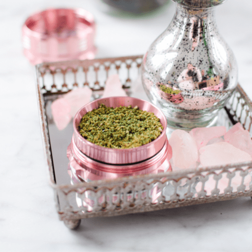 A picture of just decarbed cannabis in a pink container.