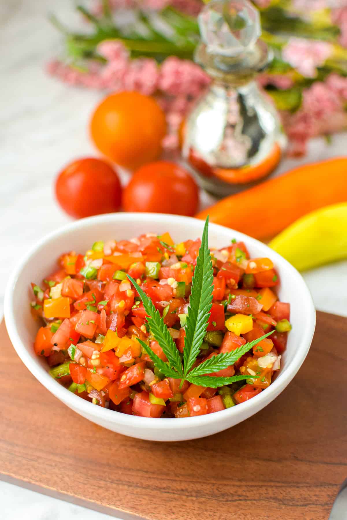 A finished bowl of cannabis infused salsa garnished with a cannabis fan leaf