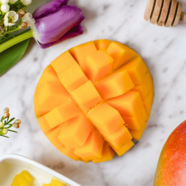 A picture of a mango on a white countertop.