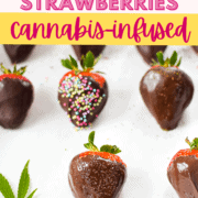 A baking sheet topped with parchment paper topped with several cannabis chocolate covered strawberries