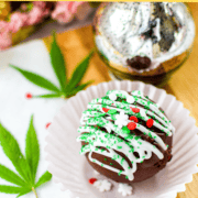 A final image shot of a cannabis hot cocoa bomb inside a white cupcake liner.