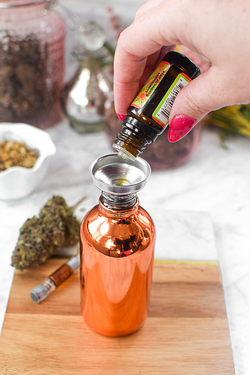 CBD oil being poured into a serum bottle for skincare.