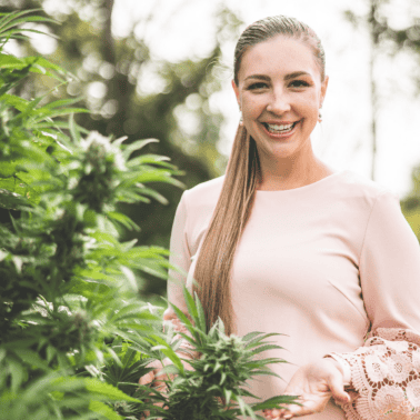 A picture of Emily Kyle with a cannabis plant.