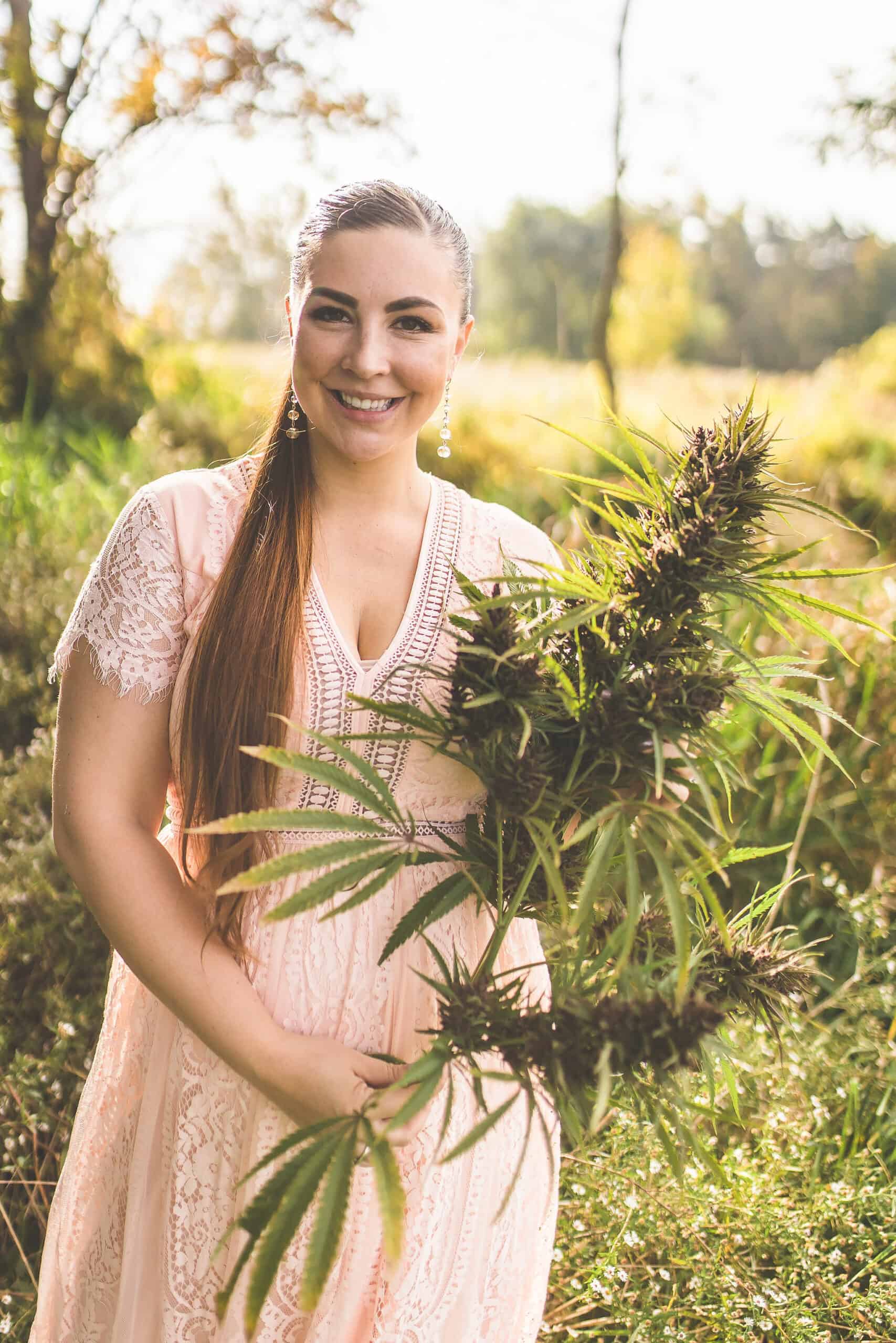 A picture of Emily Kyle holding cannabis plants.