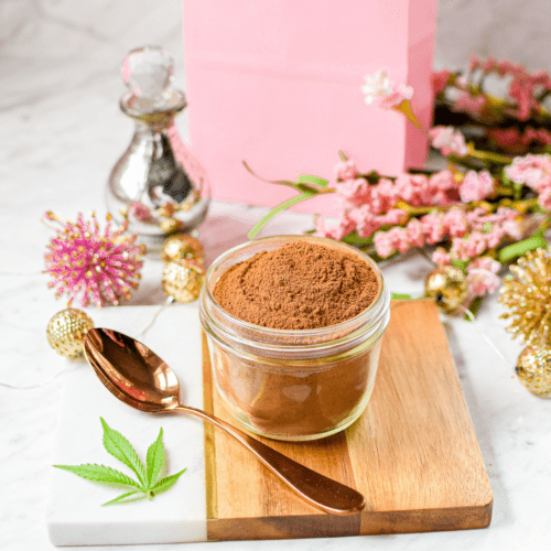 A picture of a jar full of cannabis hot cocoa.