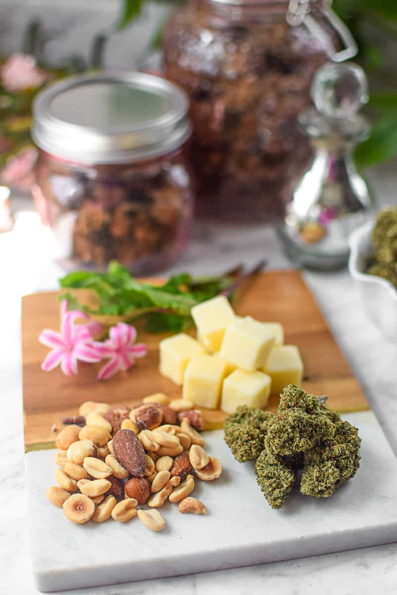 A picture of cannabis buds with high fat foods like cheese and nuts.