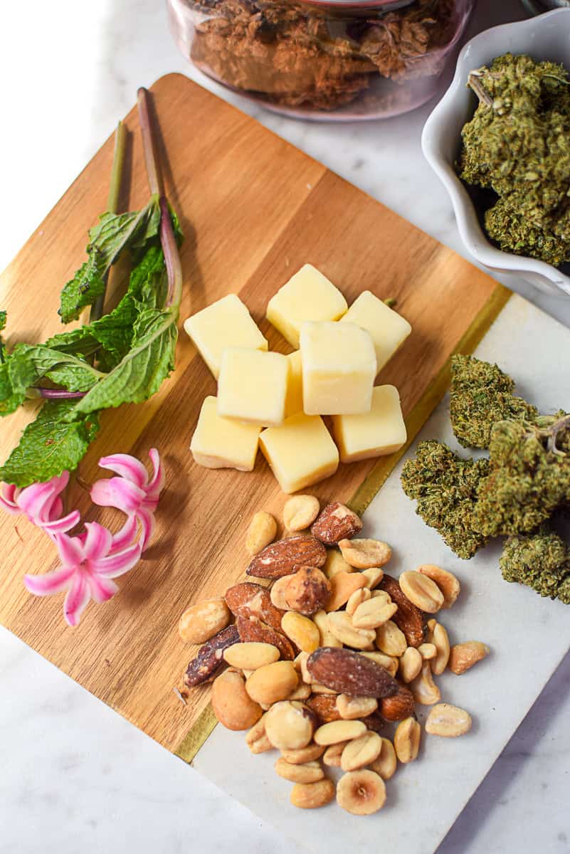 A picture of cannabis buds with high fat foods like cheese and nuts.