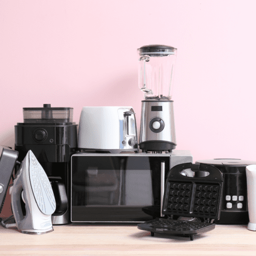 A pink background with appliances like a microwave.