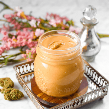 A white countertop with a jar of cannabis peanut butter