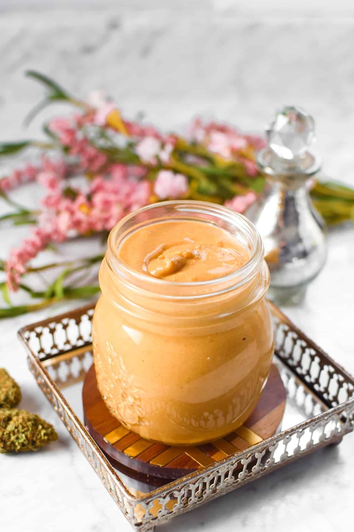 A white countertop with a jar of cannabis peanut butter