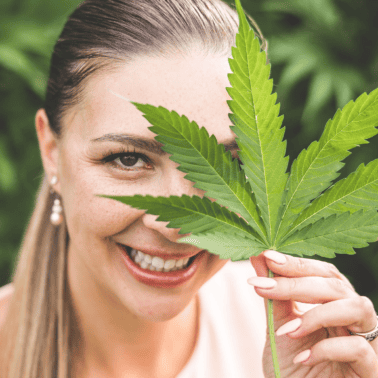 A picture of Emily Kyle with a cannabis leaf over her eye.