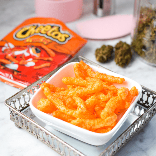 A white bowl filled with cannabis infused Cheetos.
