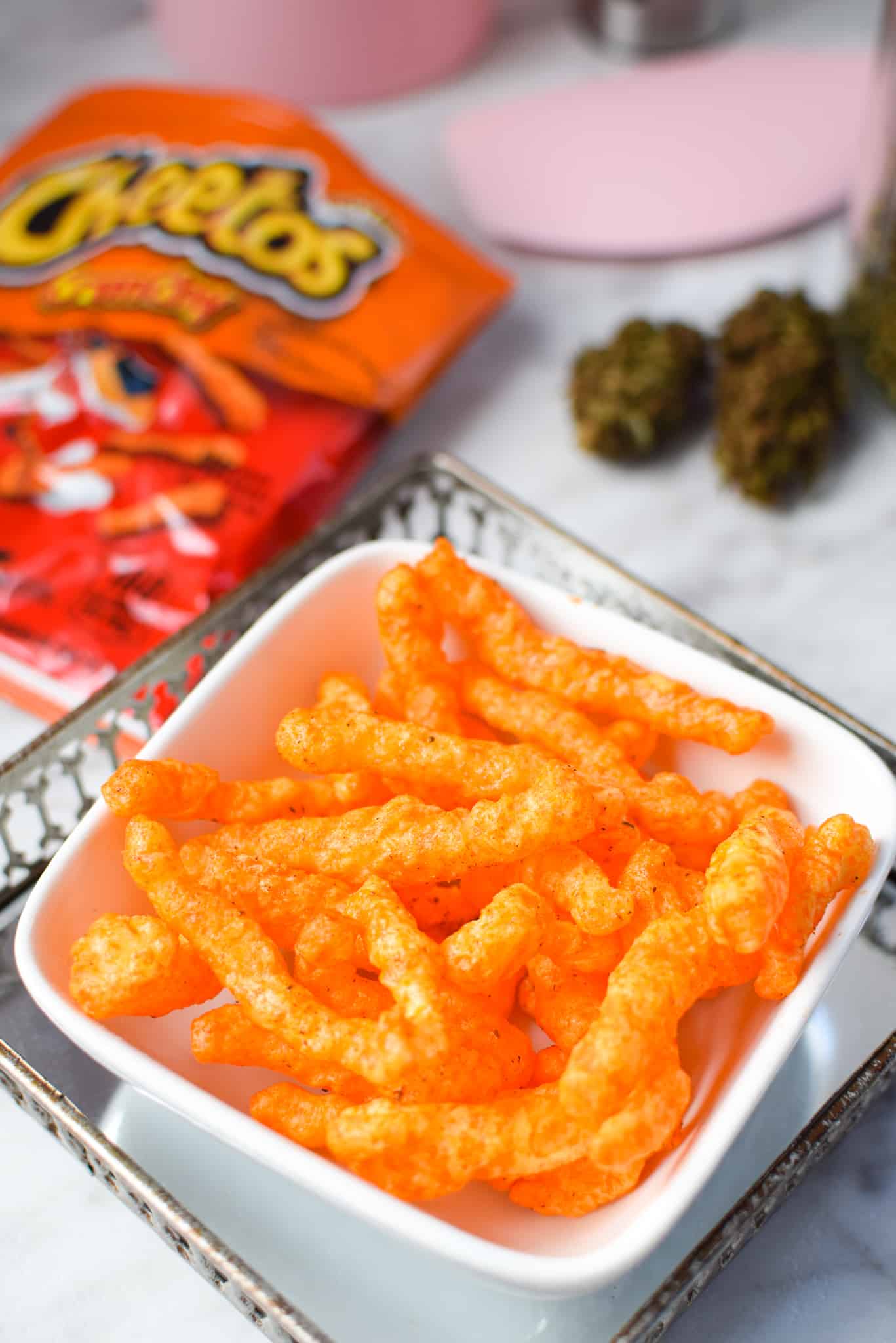 A white bowl filled with cannabis infused Cheetos.