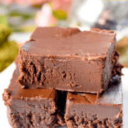 A white plate with stacked pieces of cannabis fudge.