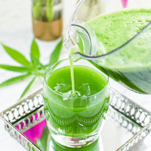A picture of green cannabis juice being poured into a glass.