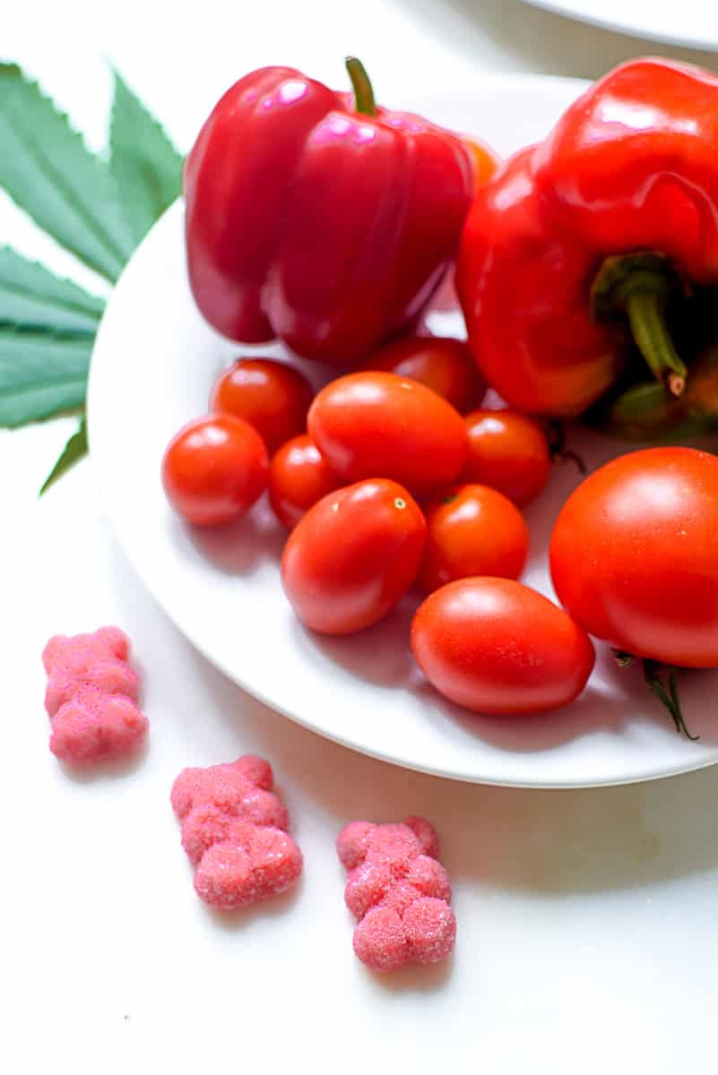 A picture of cannabis gummies and grape tomatoes.