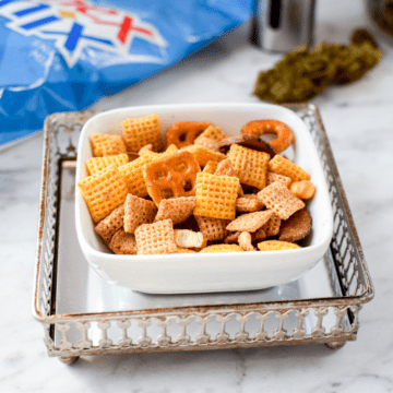 A picture of a while bowl containing cannabis chex mix.