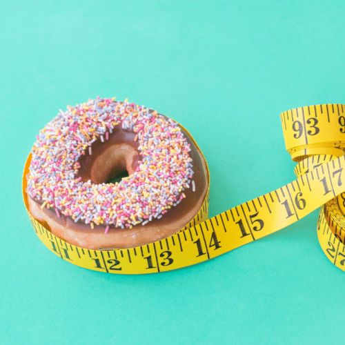 A picture of a donut and a waist measuring tape.