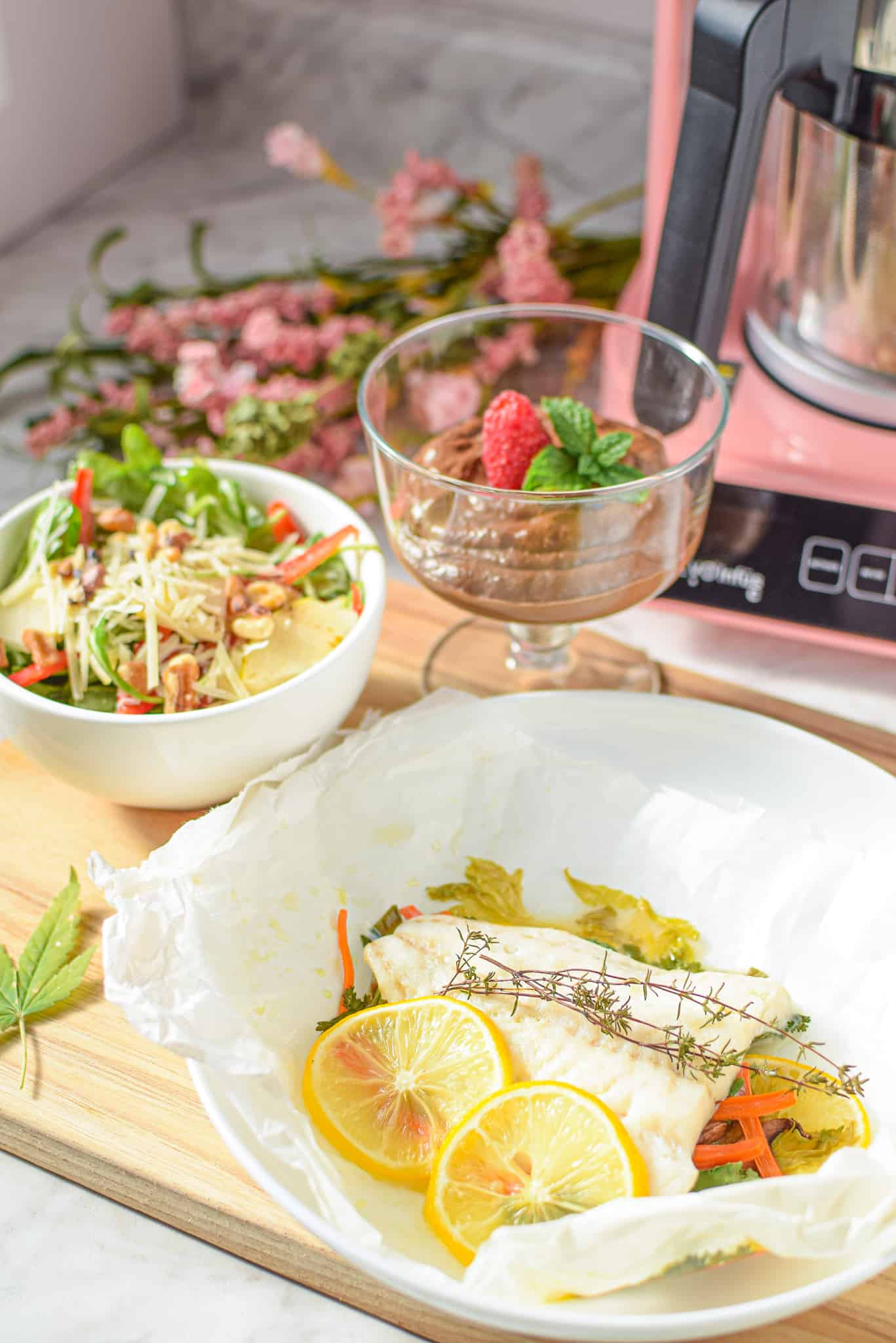 A picture of three dishes for a cannabis-infused dinner party, a salad, a dessert, and a fish entree.