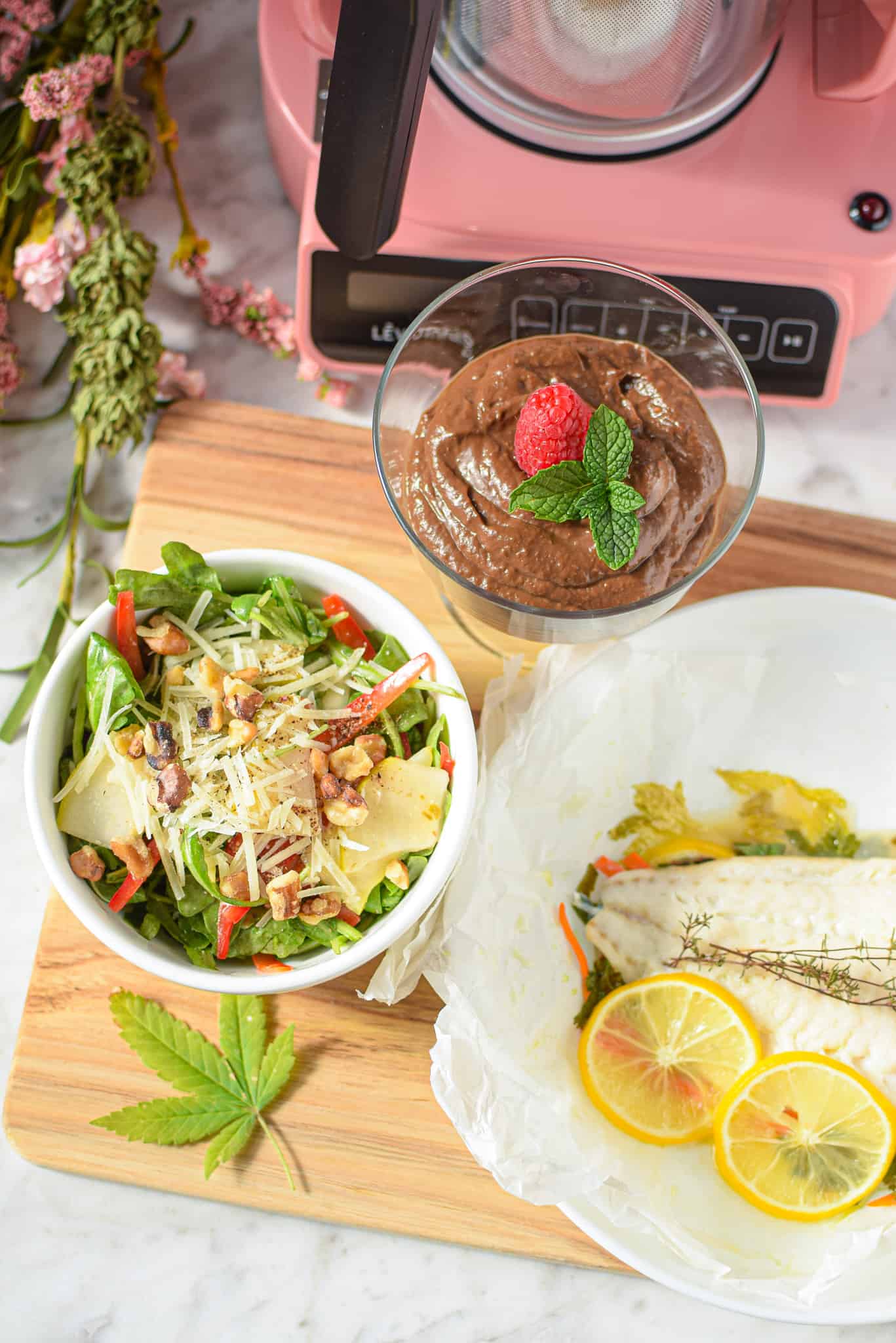 A picture of three infused courses for a cannabis-infused dinner party including chocolate pudding, salad, and fish. 