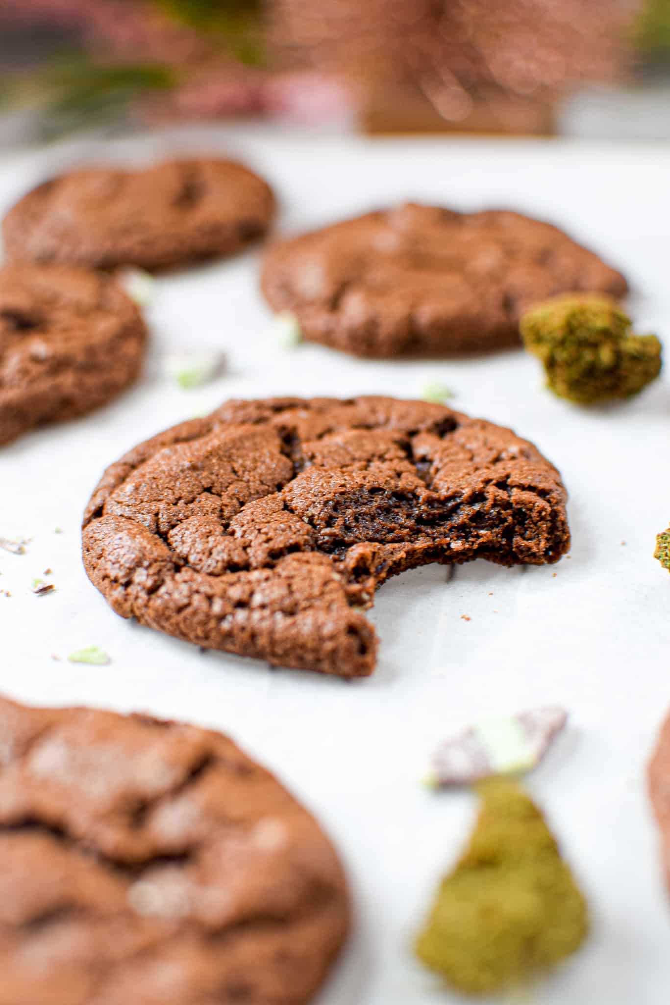 A picture of a chocolate mint cannabis cookie with a bite taken out.