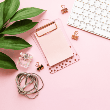 A picture a pink desk with pink papers.