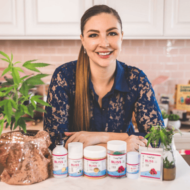 A picture of Emily Kyle with her cannabis products to help with pain.