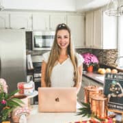 A picture of Emily Kyle in a kitchen holding a gummy bear.