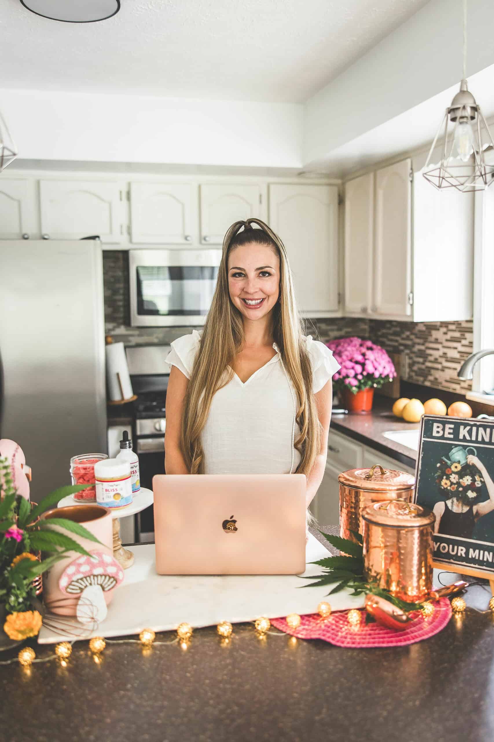 A picture of Emily Kyle in a kitchen holding a gummy bear.