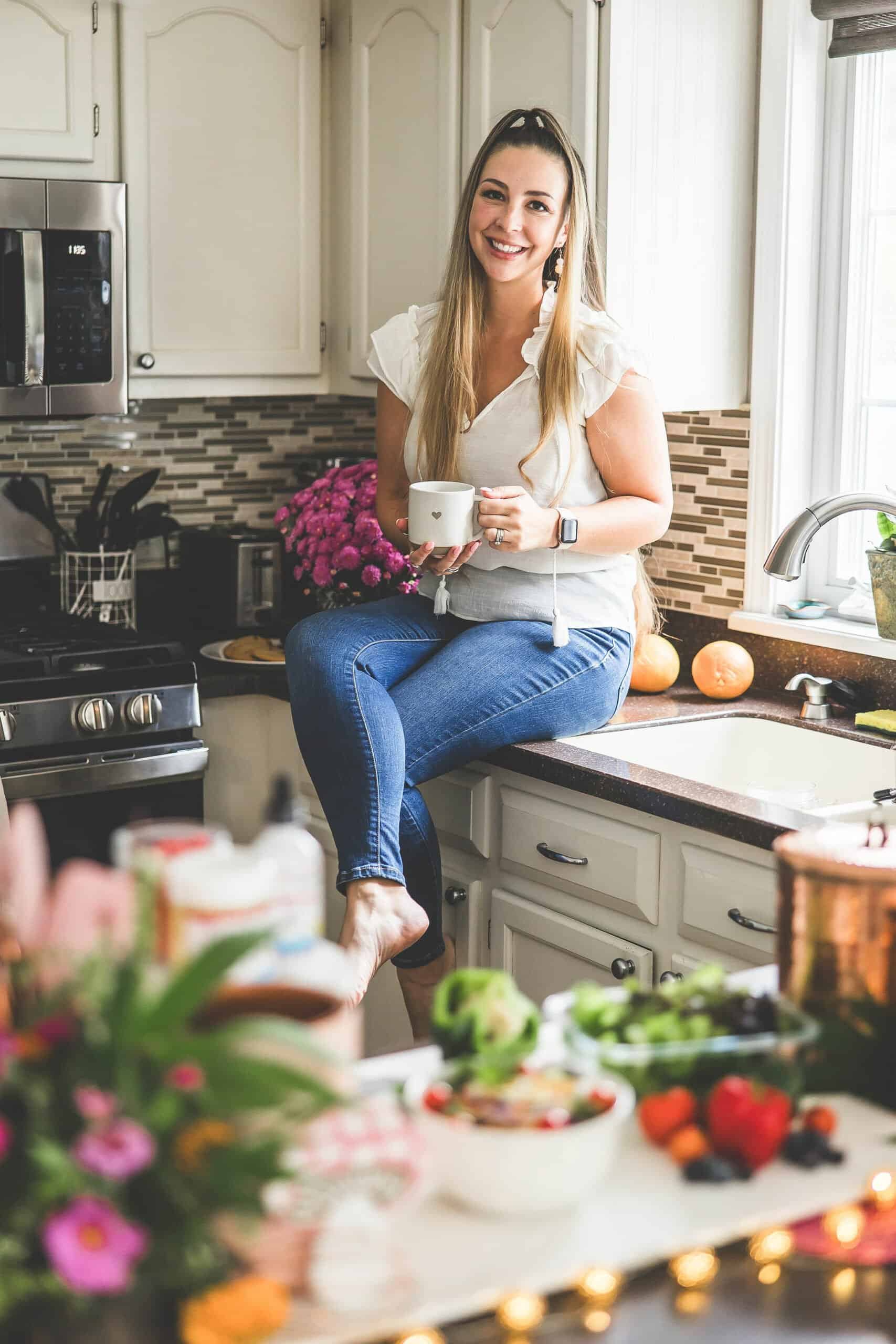 A picture of Emily Kyle in a kitchen holding a gummy bear.