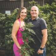 A picture of Emily Kyle and Phil Kyle with cannabis plants.
