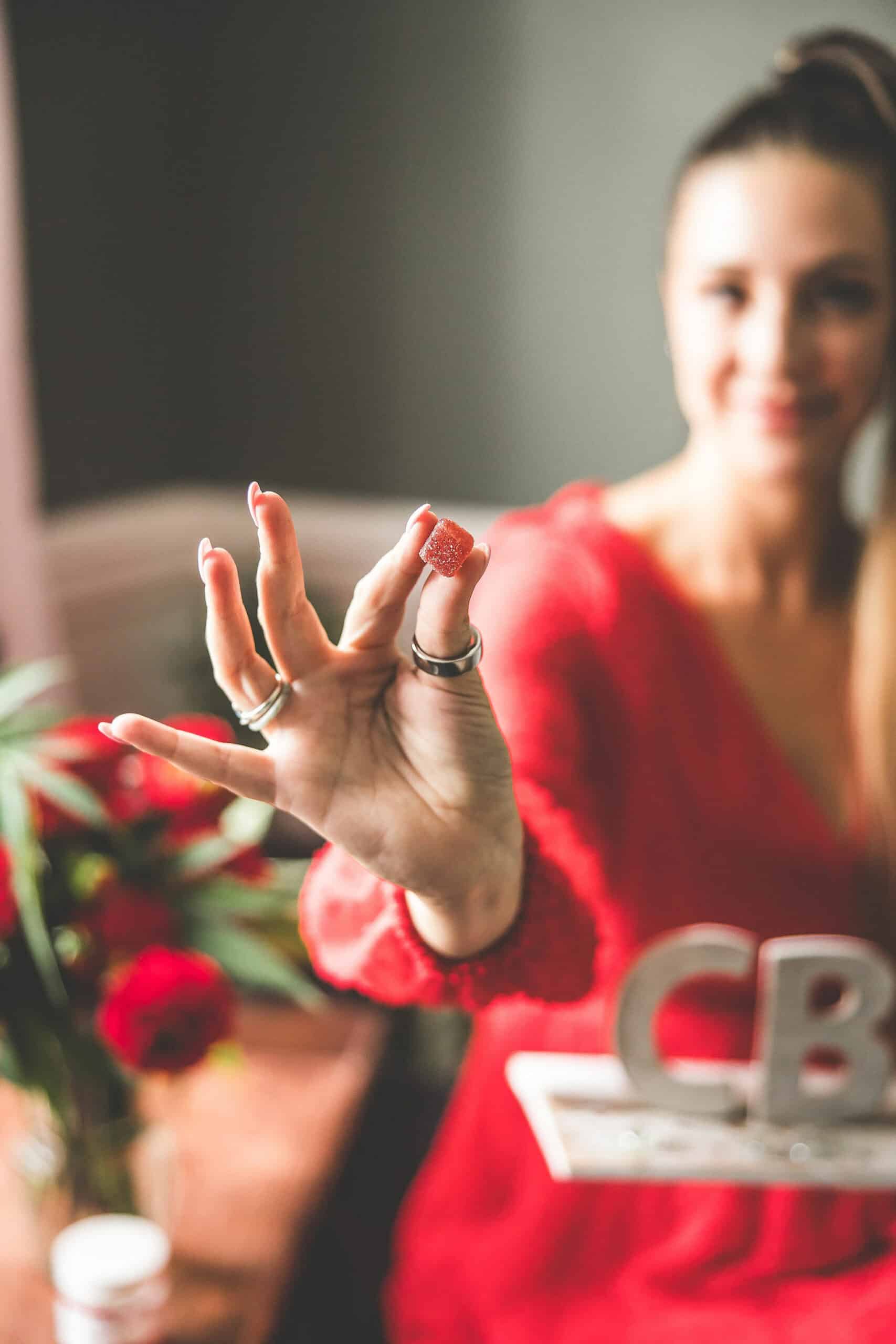 A picture of Emily Kyle holding a CBD sign.