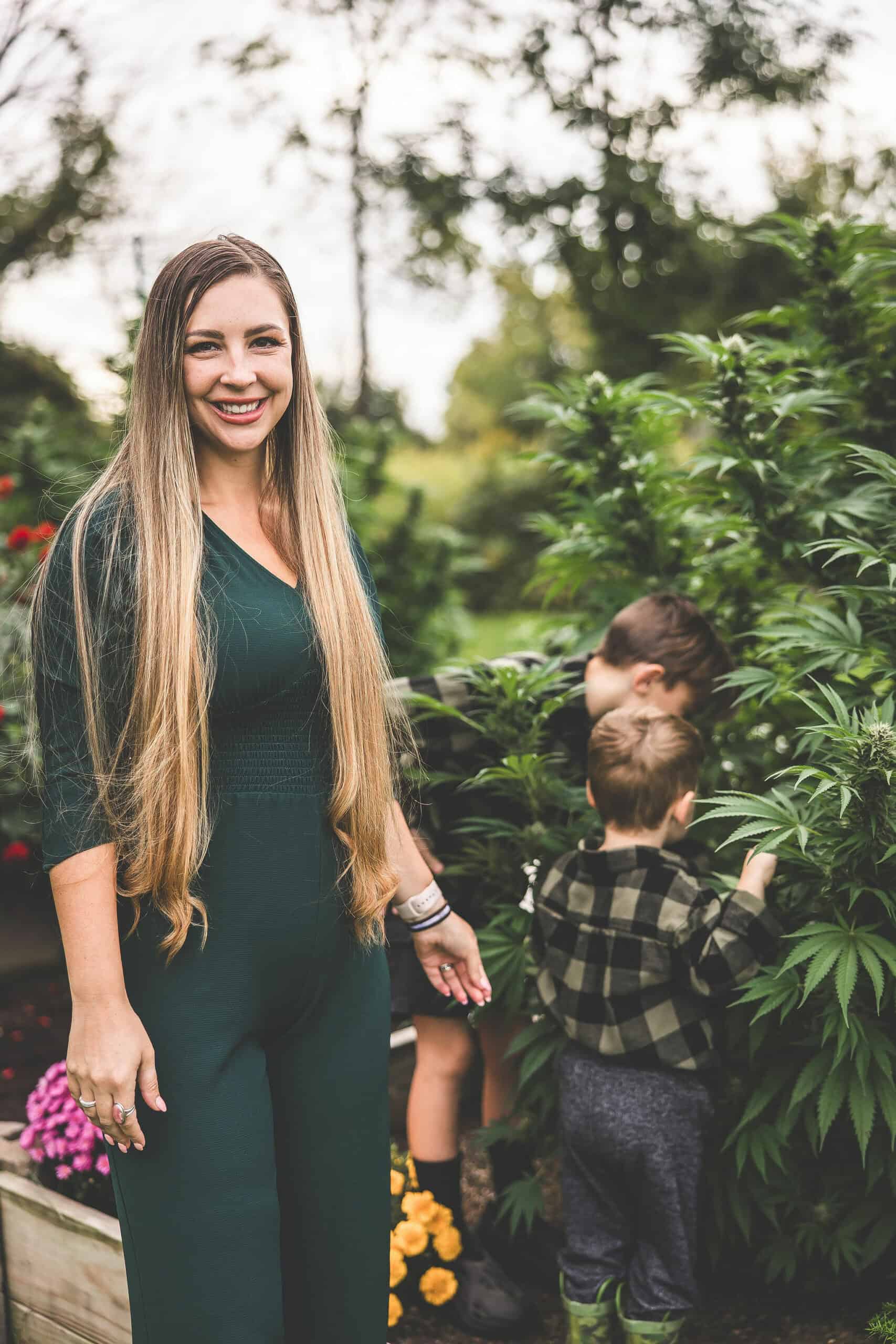 A picture of Emily Kyle and her family in a cannabis garden.