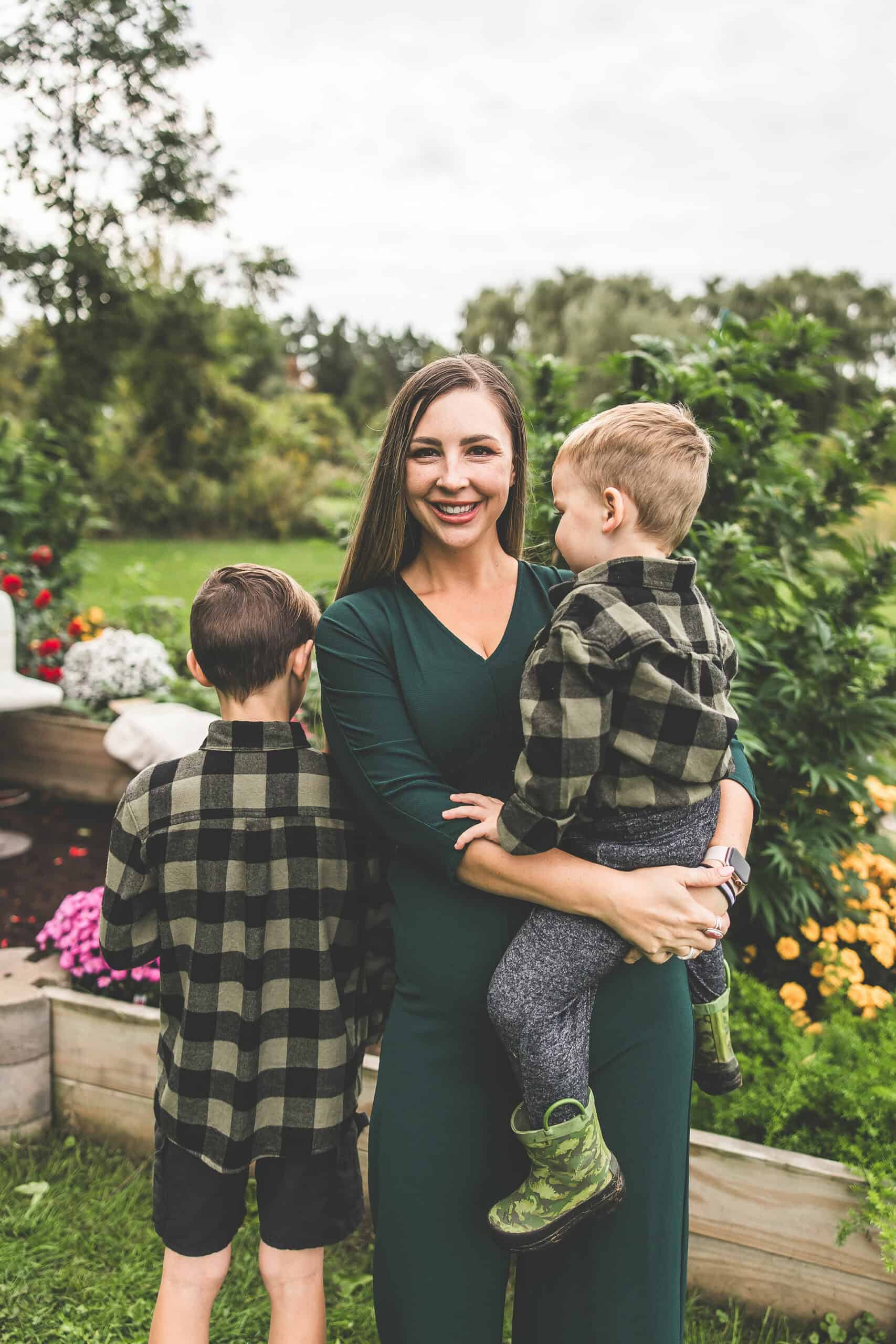 A picture of Emily Kyle and her family in a cannabis garden.